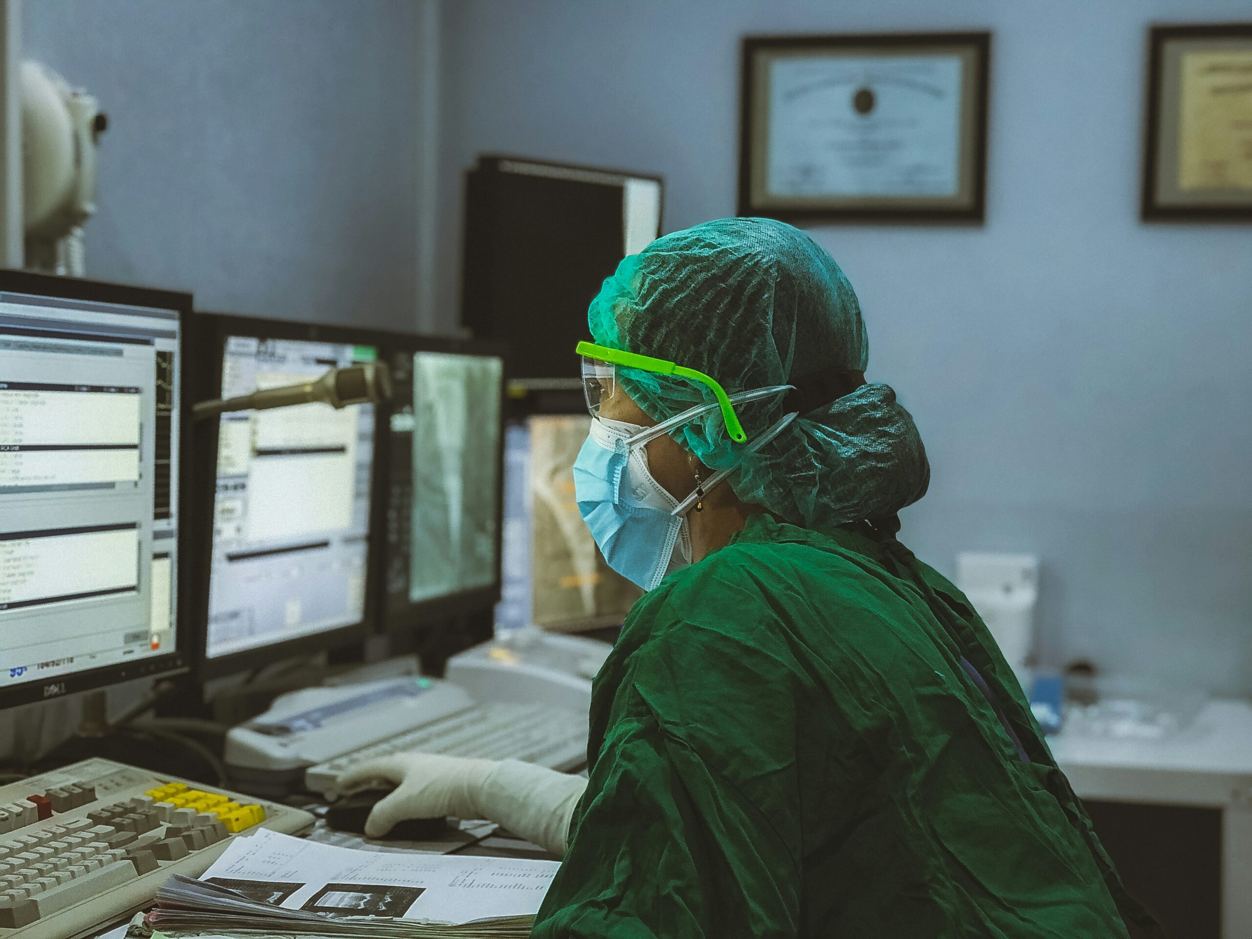 Image shows a heathcare worker in a hospital office building.